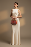 Model in neutral dress holding ROUGE bag